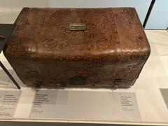 Antique personal travel trunk displayed at La Poste Museum