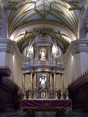 Altar inside a historic cathedral with ornate gold decorations and religious symbols