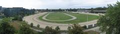 Panoramic view of Krieau Trabrennbahn horse racing track with grandstands and a crowd