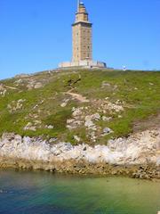 Lighthouse Torre de Hércules in A Coruña at sunset with blue sky and sea