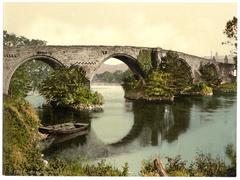 Old bridge over the river in Stirling, Scotland with historic buildings in the background