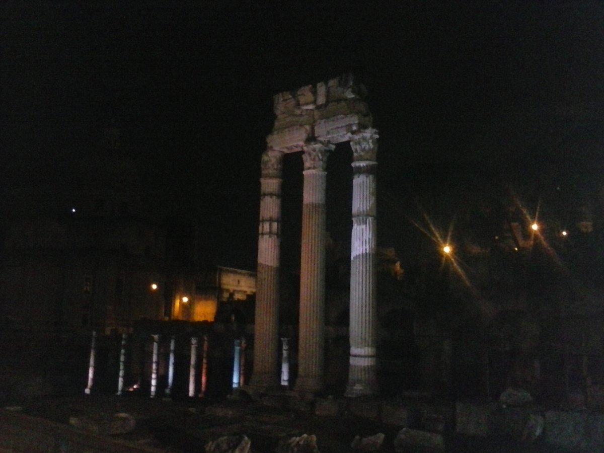 View of ancient Roman Imperial Forums in Rome with historic ruins and clear skies