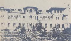 Vrana Palace in Bulgaria surrounded by greenery under blue sky