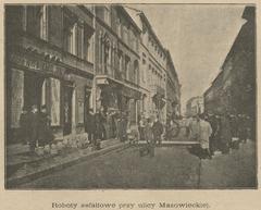 Asphalt paving work on Mazowiecka Street with construction machinery and workers