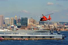 U.S. Coast Guard MH-65 Dolphin helicopter flying over Baltimore Inner Harbor during Star-Spangled Spectacular event