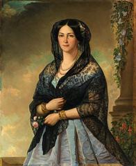 Woman in light blue suit with black lace scarf on head and shoulders