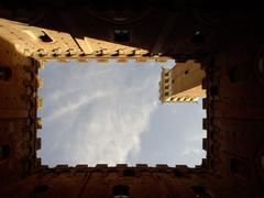 Cortile del Podestà courtyard in Siena with historic architecture and stone buildings