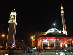 Clock Tower and Et'hem Bey Mosque illuminated at night in Tirana