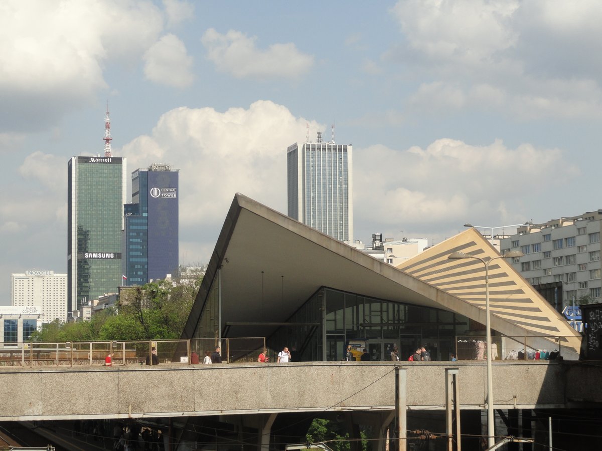 Warszawa Ochota railway station platform with tracks and overhead electric lines on a cloudy day