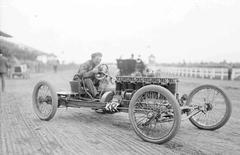 Carl G. Fisher sitting in a racing car at Harlem Race Track in Forest Park, Illinois