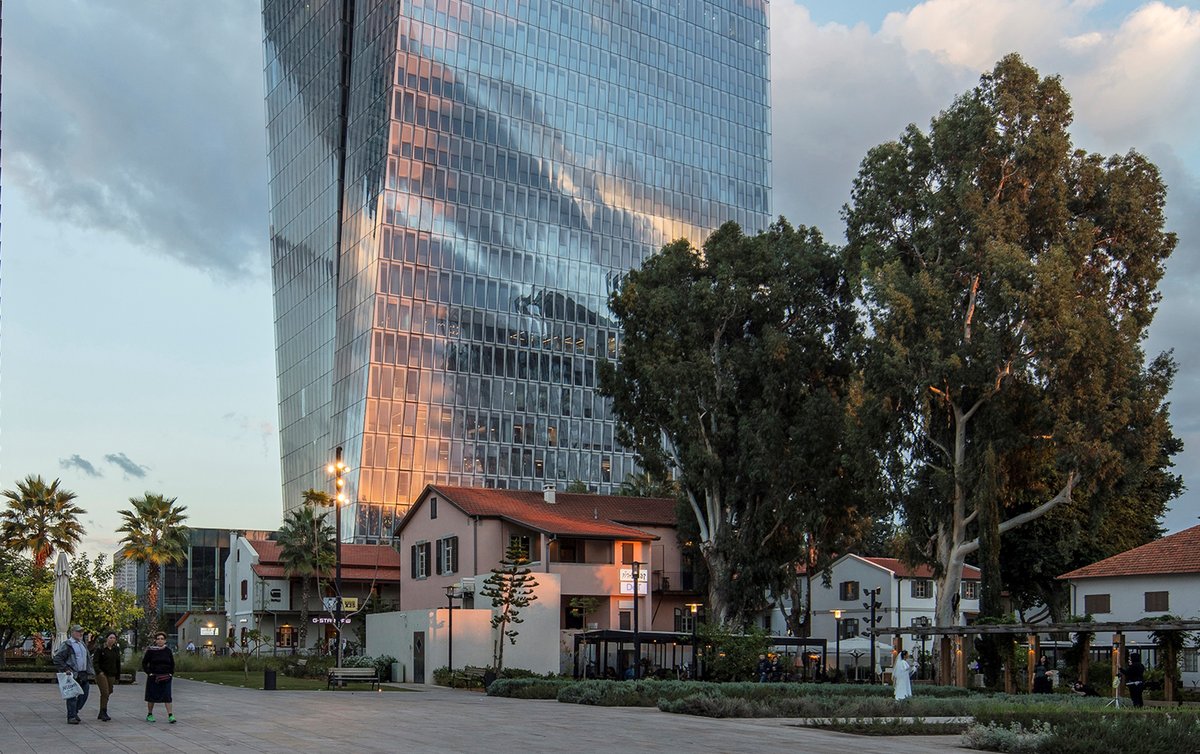 Azrieli Sarona complex in Tel Aviv at sunset with glass skyscrapers