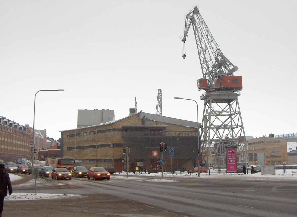 Red harbor crane in Helsinki with bright blue sky