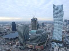 Panorama city view from the Palace of Culture and Science observation deck in Warsaw showing Zlote Tarasy, Varso Tower under construction, and Zlota 44 skyscraper