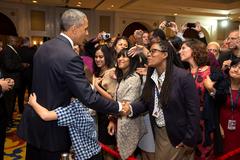 Young boy hugging President Barack Obama during greeting with U.S. Embassy personnel in New Delhi