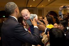 Unhappy baby being pushed to greet President Obama at U.S. Embassy in New Delhi