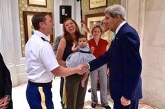 US Secretary of State John Kerry laughing and shaking hands with US Embassy New Delhi staff
