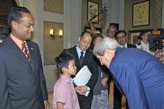 U.S. Secretary of State John Kerry chatting with a child in New Delhi