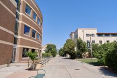 Pedestrian walkway in Summit Village student housing with landscaped greenery and modern buildings