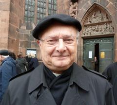 Archbishop Dr. Robert Zollitsch standing before the blessing gate of Freiburg Minster after the 2011 Christmas service