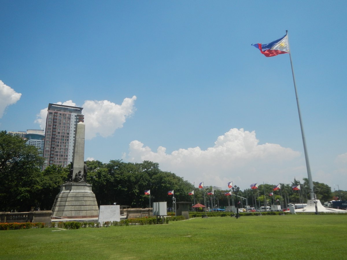 Rizal Park landmarks including Jose Rizal National Monument, Independence Flagpole, and historical markers in Manila, Philippines