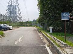 Parking area at Muhibbah LRT Station in Kuala Lumpur with buses and surrounding buildings