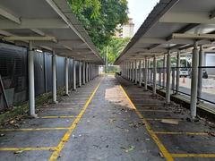 Park and Ride area at Muhibbah LRT Station in Kuala Lumpur with parked cars and greenery