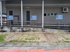 Car park area at Muhibbah LRT Station in Kuala Lumpur with parked vehicles and surrounding buildings