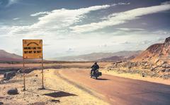 Motorbike rider on Manali-Leh Highway near Stakna village in Ladakh mountains