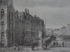 View of Place de l'Académie in Bruges with historic buildings and people walking