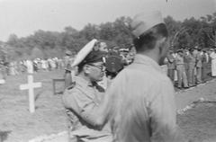 Military personnel with a film camera during World War II commemorations at Antjol cemetery, Batavia, 1946