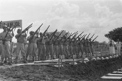 Military honor salute during reburial ceremony of executed soldiers of Marine and KNIL at Antjol war cemetery in Jakarta, Indonesia in 1946