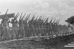 Military honor salute at reburial ceremony of executed Marines and KNIL soldiers at Antjol cemetery in Batavia, 1946