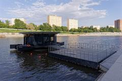 Moscow Derbenyovskaya Embankment ferry terminal on a clear day with people and boats