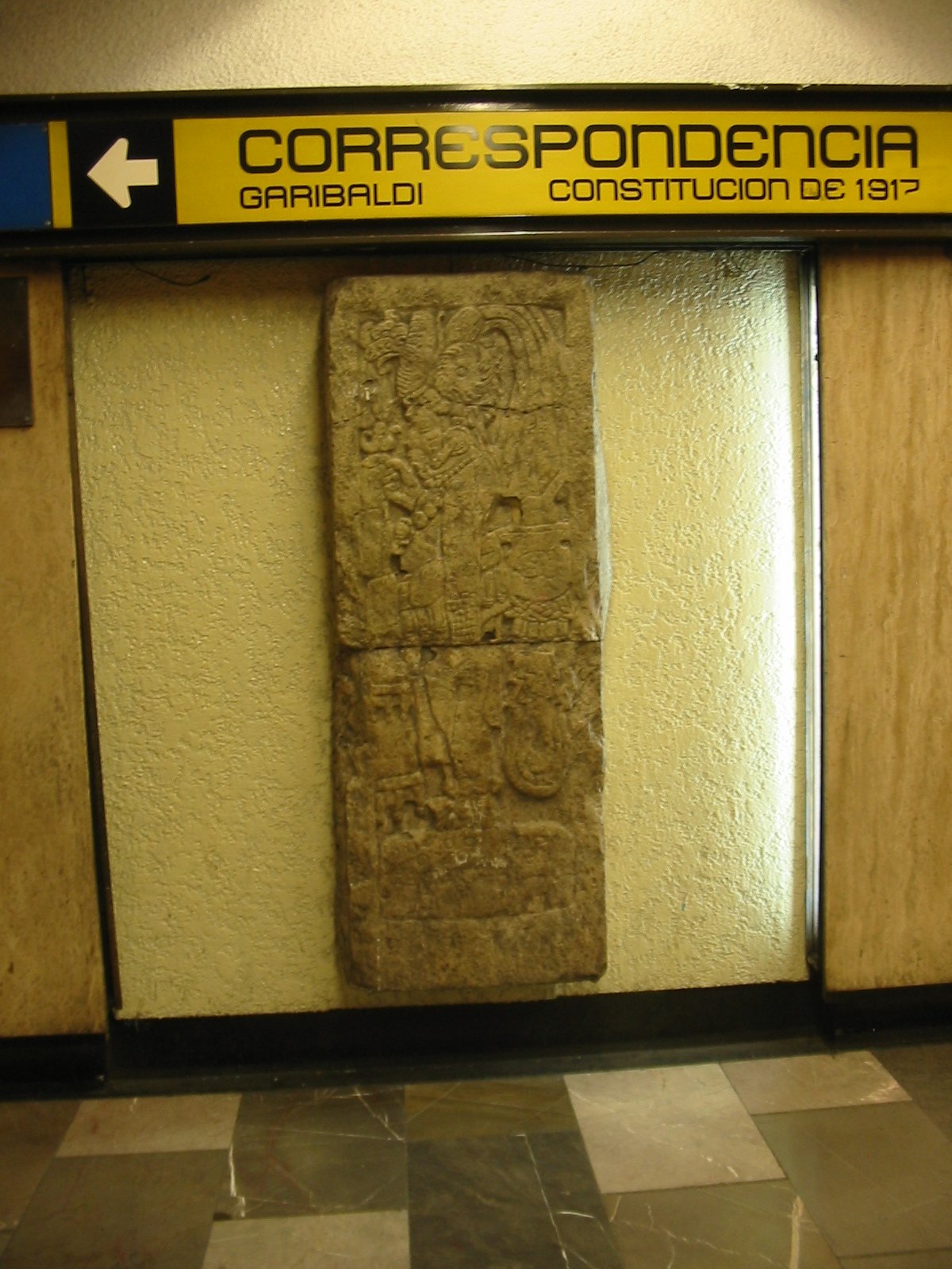 Replica of a Mayan stele from Calakmul showing a governor with feathered headdress and manniquin sceptre at Metro Bellas Artes, Mexico City