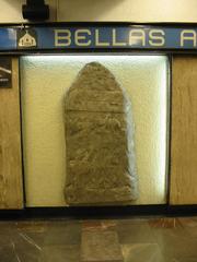 Replica of Izapa gravestone with bas relief of a person loading something at Metro Bellas Artes in Mexico City