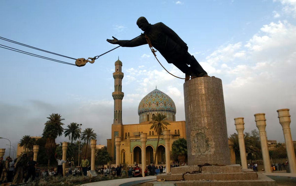 Statue of Saddam Hussein toppling in Baghdad's Firdos Square during US invasion of Iraq