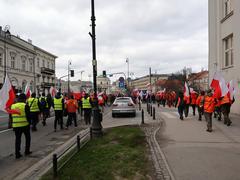 Farmers protesting in Warsaw holding flags and banners
