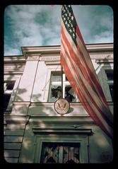 American Embassy in Warsaw showing shattered window with American flag after German air raid in September 1939