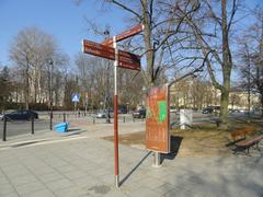 MSI pedestrian signpost near Ujazdowskie Avenue in Warsaw with Belweder in the background