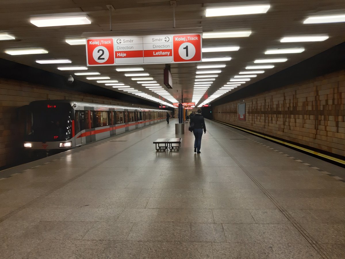 Metro station in Prague with trains on both sides of the platform