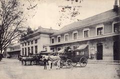 Historic postcard of Avignon train station showing early 20th century architecture and street scene