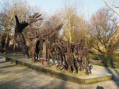 Oosterpark Slavery Monument in Amsterdam during daytime with green trees and blue sky