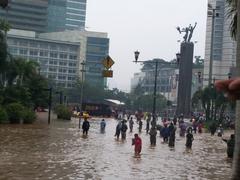 People walking through flooded streets in Jakarta, Indonesia