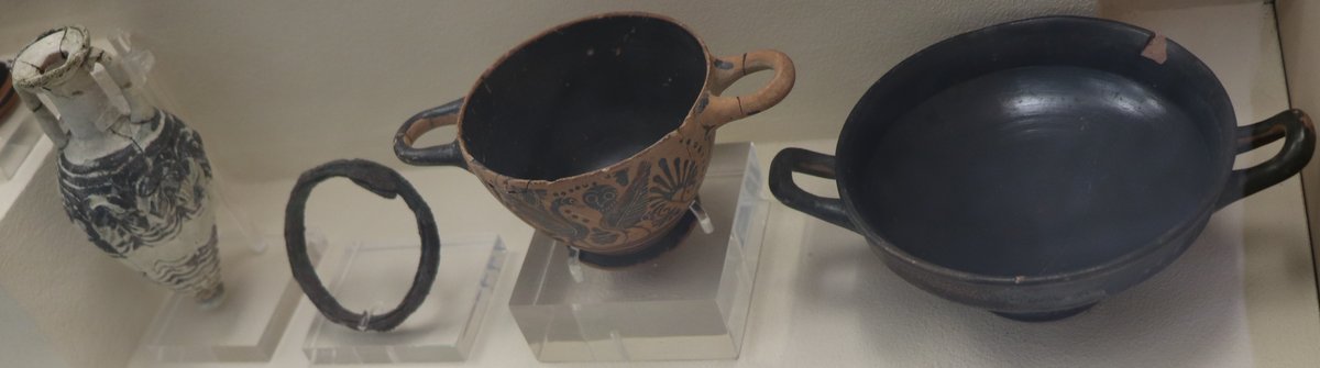 Assemblage of ancient artifacts from Eleusis Tomb 472-VII displayed at the Archaeological Museum