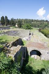 Ancient Roman theatre ruin in Fiesole under a clear sky