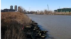 Bronx Kill waterway separating Randall's Island from the Bronx with Harlem River in the background and old Willis Avenue Bridge visible