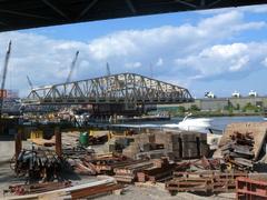 View looking north under Manhattan leg of Triboro Bridge at new bridge on sunny afternoon