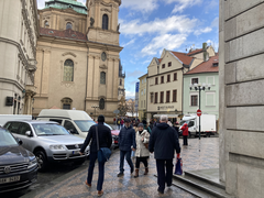 Street scene in Prague the day after a shooting, with people walking and life going on