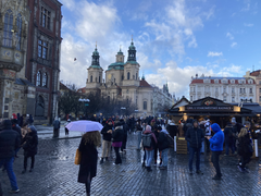 Street scene in Prague the day after a shooting, showing normal urban life continuing