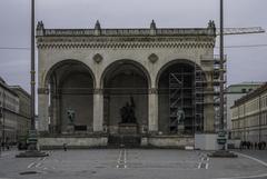 Feldherrnhalle neoclassical loggia with three arches and statues on Odeonsplatz in Munich under overcast sky